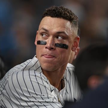 Sep 13, 2024; Bronx, New York, USA; New York Yankees center fielder Aaron Judge (99) looks back from the dug out during the third inning against the Boston Red Sox at Yankee Stadium. Mandatory Credit: Vincent Carchietta-Imagn Images