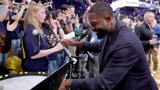 Mar 13, 2025; New York, NY, USA; Marquette Golden Eagles former player Dwyane Wade plays the drum with the school's band after defeating the Xavier Musketeers at Madison Square Garden. Mandatory Credit: Brad Penner-Imagn Images