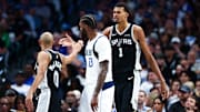 Oct 22, 2025; Dallas, Texas, USA; San Antonio Spurs forward Victor Wembanyama (1) celebrates with guard Jordan McLaughlin (0) in front of Dallas Mavericks forward Naji Marshall (13) during the first half  at American Airlines Center.