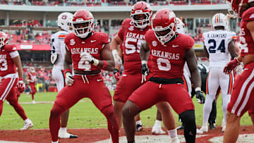 Oct 25, 2025; Fayetteville, Arkansas, USA; Arkansas Razorbacks running back Mike Washington Jr (4) celebrates with offensive lineman Fernando Carmona (55) and running back Braylen Russell (0) after scoring a touchdown during the second quarter against the Auburn Tigers at Donald W. Reynolds Razorback Stadium. Mandatory Credit: Nelson Chenault-Imagn Images