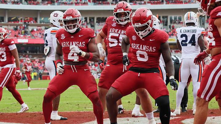 Oct 25, 2025; Fayetteville, Arkansas, USA; Arkansas Razorbacks running back Mike Washington Jr (4) celebrates with offensive lineman Fernando Carmona (55) and running back Braylen Russell (0) after scoring a touchdown during the second quarter against the Auburn Tigers at Donald W. Reynolds Razorback Stadium. Mandatory Credit: Nelson Chenault-Imagn Images