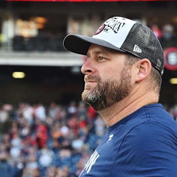 Sep 28, 2025; Cleveland, Ohio, USA;  Cleveland Guardians manager Stephen Vogt (12) watches the flag raising after the Guardians beat the Texas Rangers and won the American League Central Division at Progressive Field. Mandatory Credit: Ken Blaze-Imagn Images
