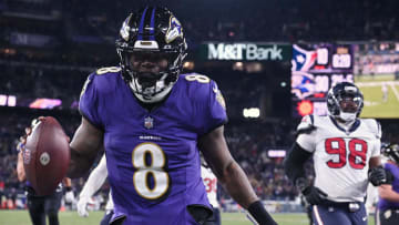 Jan 20, 2024; Baltimore, MD, USA; Baltimore Ravens quarterback Lamar Jackson (8) runs the ball to score a touchdown against Houston Texans defensive tackle Sheldon Rankins (98) 