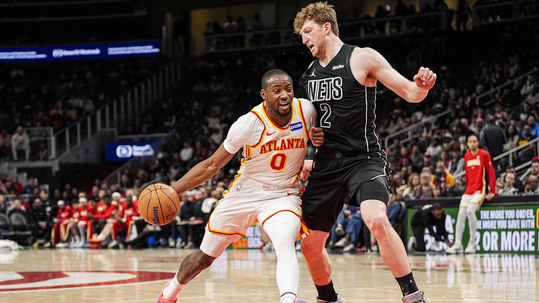 Mar 12, 2026; Atlanta, Georgia, USA; Atlanta Hawks forward Jonathan Kuminga (0) dribbles against Brooklyn Nets forward Danny Wolf (2) during the second half at State Farm Arena. Mandatory Credit: Dale Zanine-Imagn Images