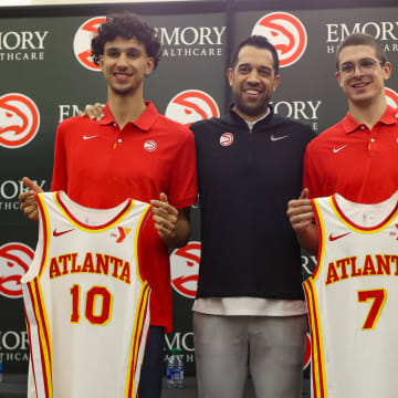 Jun 28, 2024; Atlanta, Georgia, USA; Atlanta Hawks first overall draft pick Zaccharie Risacher and general manager Landry Fields and second round draft pick Nikola Djurisic pose for a photo with jerseys at the Emory Sports Medicine Complex. Mandatory Credit: Brett Davis-USA TODAY Sports
