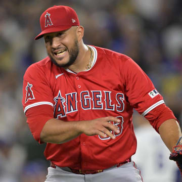 Jun 21, 2024; Los Angeles, California, USA;  Los Angeles Angels relief pitcher Carlos Estevez (53) reacts after striking out Los Angeles Dodgers second baseman Gavin Lux (9) in the 10th inning earning a save in the game at Dodger Stadium