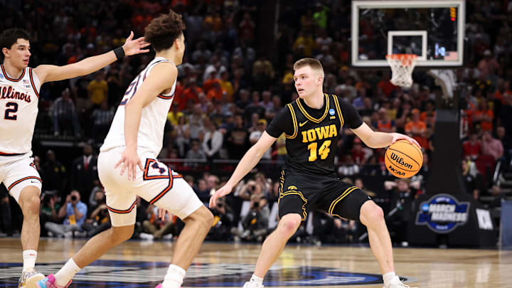 Mar 28, 2026; Houston, TX, USA; Iowa Hawkeyes guard Bennett Stirtz (14) controls the ball against Illinois Fighting Illini guard Keaton Wagler (23) in the second half during an Elite Eight game of the South Regional of the men's 2026 NCAA Tournament at Toyota Center. Mandatory Credit: Troy Taormina-Imagn Images