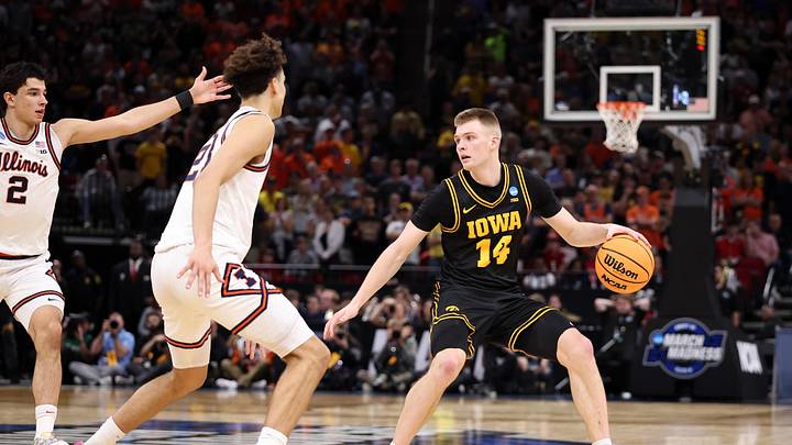 Mar 28, 2026; Houston, TX, USA; Iowa Hawkeyes guard Bennett Stirtz (14) controls the ball against Illinois Fighting Illini guard Keaton Wagler (23) in the second half during an Elite Eight game of the South Regional of the men's 2026 NCAA Tournament at Toyota Center. Mandatory Credit: Troy Taormina-Imagn Images