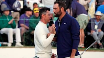 Apr 12, 2024; Augusta, Georgia, USA; Rory McIlroy shakes hands with Scott Scheffler on the 18th green during the second round of the Masters Tournament at Augusta National Golf Club. Mandatory Credit: Michael Madrid-USA TODAY Network