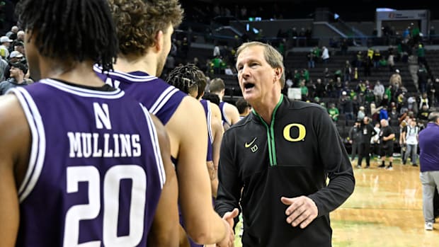 Oregon Ducks head coach Dana Altman shakes hands with the Northwestern Wildcats players post game at Matthew Knight Arena