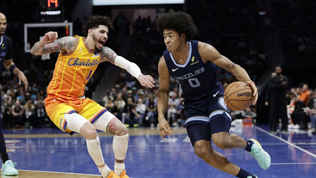 Mar 21, 2026; Charlotte, North Carolina, USA; Memphis Grizzlies forward Jaylen Wells (0) drives past Charlotte Hornets guard LaMelo Ball (1) during the second quarter at Spectrum Center. Mandatory Credit: Brian Westerholt-Imagn Images