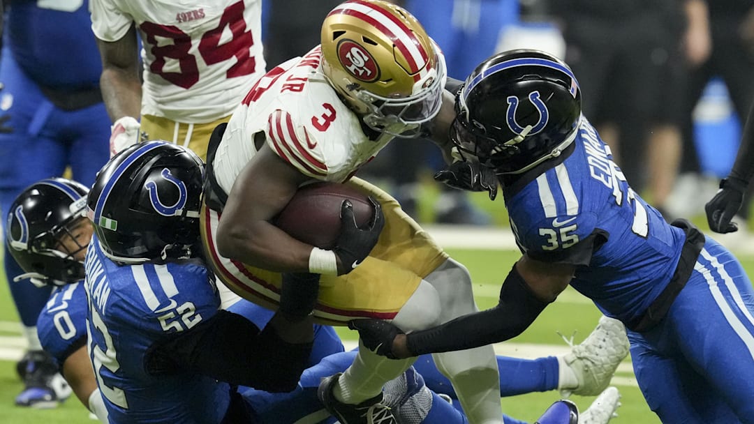 San Francisco 49ers running back Brian Robinson Jr. (3) is brought down by Indianapolis Colts defensive end Samson Ebukam (52).