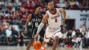 Feb 25, 2025; Tuscaloosa, Alabama, USA; Alabama Crimson Tide guard Chris Youngblood (8) drives against Mississippi State Bulldogs guard Dellquan Warren (6) and guard Riley Kugel (2) during the second half at Coleman Coliseum. Mandatory Credit: Will McLelland-Imagn Images