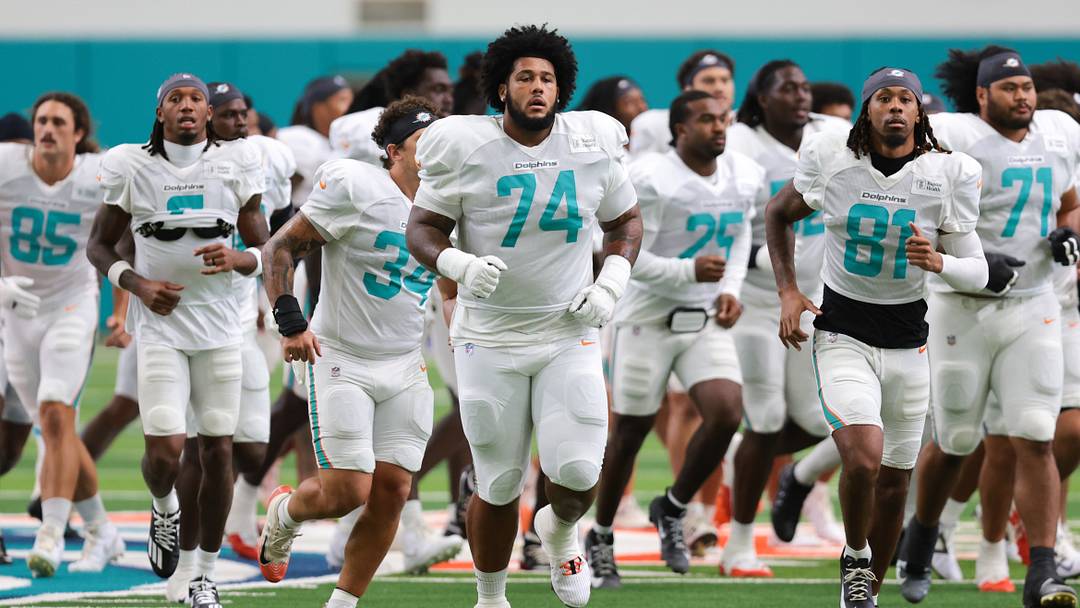 Miami Dolphins offensive lineman Kadyn Proctor (74) runs on the field during joint practice with the New York Giants at Baptist Health Training Complex. Miami Dolphins offensive lineman Kadyn Proctor (74) runs on the field during joint practice with the New York Giants at Baptist Health Training Complex.