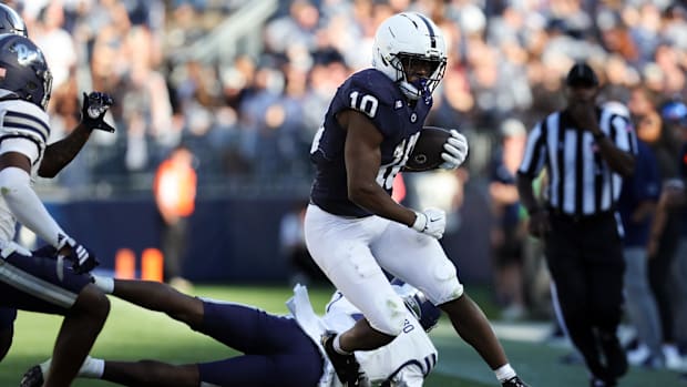 Penn State Nittany Lions running back Nicholas Singleton avoids a tackle while running with the ball vs. the Nevada Wolf Pack