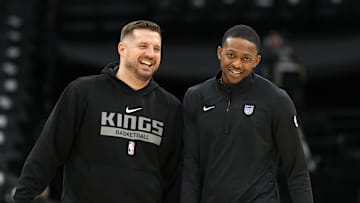 Nov 24, 2024; Sacramento, California, USA; Sacramento Kings guard De'Aaron Fox (right) and assistant coach Luke Loucks (left) talk before the game against the Brooklyn Nets at Golden 1 Center. Mandatory Credit: Darren Yamashita-Imagn Images