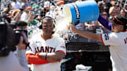 San Francisco Giants shortstop Willy Adames (right) douses teammate Rafael Devers following their victory over the Boston Red Sox at Oracle Park.