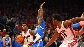 Dec 14, 2024; Phoenix, Arizona, USA; Arizona Wildcats guard Caleb Love (1) against UCLA Bruins guard Skyy Clark (55) in the first half at Footprint Center. Mandatory Credit: Mark J. Rebilas-Imagn Images
