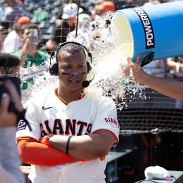 San Francisco Giants shortstop Willy Adames (right) douses teammate Rafael Devers following their victory over the Boston Red Sox at Oracle Park.