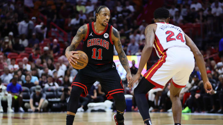 Apr 19, 2024; Miami, Florida, USA; Chicago Bulls forward DeMar DeRozan (11) dribbles the basketball as Miami Heat forward Haywood Highsmith (24) defends in the first quarter during a play-in game of the 2024 NBA playoffs at Kaseya Center. Mandatory Credit: Sam Navarro-USA TODAY Sports