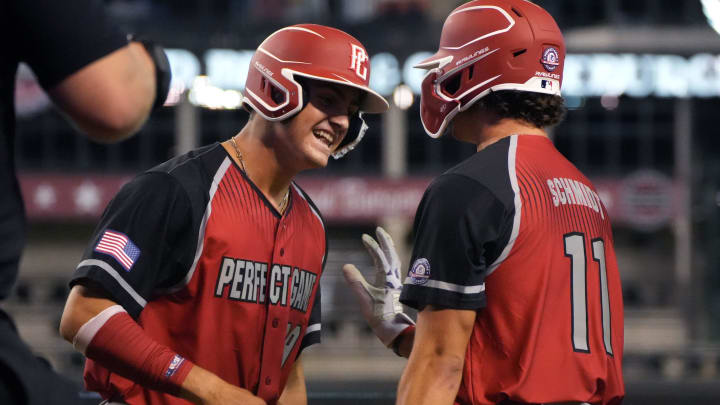 West Squad's Cooper Pratt, left, celebrates scoring a run with teammate Carl Schmidt during the Perfect Game All-American Classic at Chase Field on Sunday, Aug. 28, 2022.

Perfect Game 21