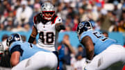 Oct 19, 2025; Nashville, Tennessee, USA;  New England Patriots linebacker Jahlani Tavai (48) points to Tennessee Titans offensive tackle JC Latham (55) during the second half at Nissan Stadium. Mandatory Credit: Steve Roberts-Imagn Images