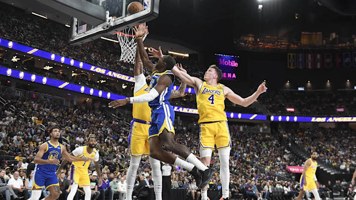 Oct 15, 2024; Las Vegas, Nevada, USA; Golden State Warriors forward Jonathan Kuminga (00) shoots against Los Angeles Lakers forward Anthony Davis (3) and guard Dalton Knecht (4) in the second quarter during a preseason game at T-Mobile Arena. Mandatory Credit: Candice Ward-Imagn Images