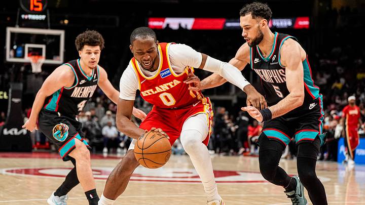 Mar 23, 2026; Atlanta, Georgia, USA; Atlanta Hawks forward Jonathan Kuminga (0) dribbles guarded by Memphis Grizzlies forward Tyler Burton (5) during the second half at State Farm Arena. Mandatory Credit: Dale Zanine-Imagn Images