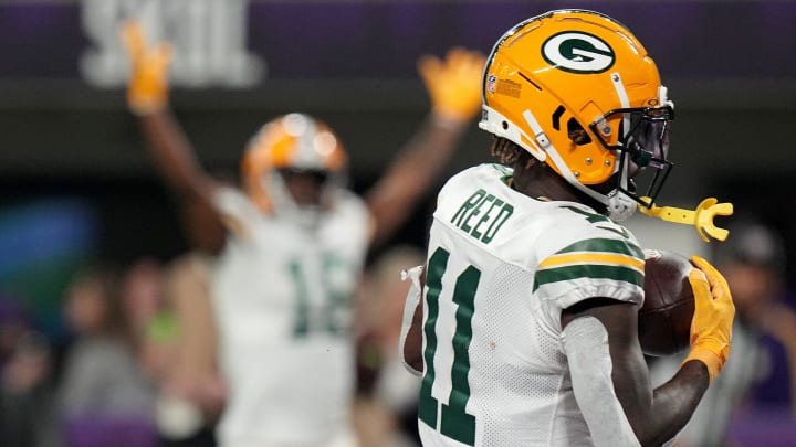 Green Bay Packers wide receiver Jayden Reed (11) scores a touchdown while Malik Heath reacts in the background at the Vikings.