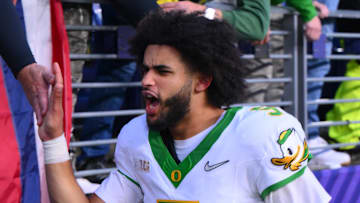Nov 29, 2025; Seattle, Washington, USA; Oregon Ducks quarterback Dante Moore (5) celebrates with fans after Oregon defeated the Washington Huskies at Husky Stadium. Mandatory Credit: Steven Bisig-Imagn Images