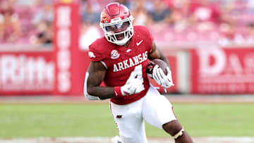 Aug 30, 2025; Fayetteville, Arkansas, USA; Arkansas Razorbacks running back Mike Washington Jr (4) rushes during the fourth quarter against the Alabama A&M Bulldogs at Donald W. Reynolds Razorback Stadium. Mandatory Credit: Nelson Chenault-Imagn Images