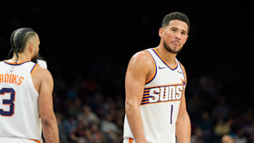 Phoenix Suns guard Devin Booker (1) reacts and sticks out his tung after a foul is called against the Suns during the second half of a game against the Atlanta Hawks at Mortgage Matchup Center. Mandatory Credit: Allan Henry-Imagn Images