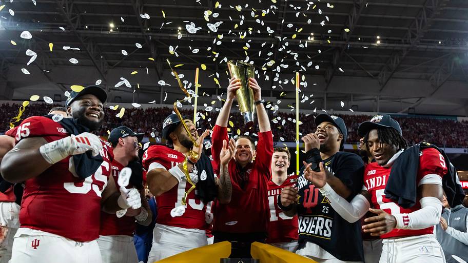 Indiana Hoosiers head coach Curt Cignetti hoists the College Football Playoff trophy.