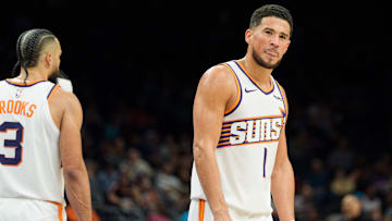 Phoenix Suns guard Devin Booker (1) reacts and sticks out his tung after a foul is called against the Suns during the second half of a game against the Atlanta Hawks at Mortgage Matchup Center. Mandatory Credit: Allan Henry-Imagn Images