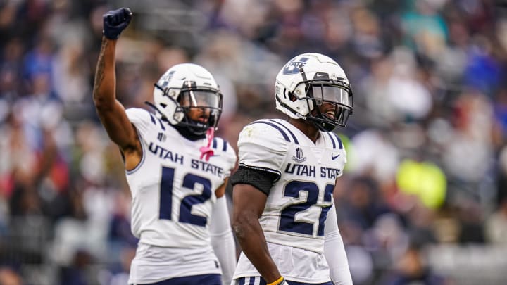 Utah State Aggies cornerback Michael Anyanwu and safety Simeon Harris react after a play during a game against the UConn Huskies in 2023. 