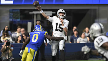 Oct 20, 2024; Inglewood, California, USA; Las Vegas Raiders quarterback Gardner Minshew (15) gets off a pass under pressure by Los Angeles Rams linebacker Byron Young (0) during the third quarter at SoFi Stadium. Mandatory Credit: Robert Hanashiro-Imagn Images