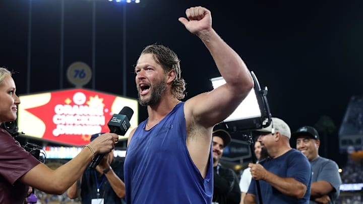 Dodgers pitcher Clayton Kershaw waves to fans during the post-game interview after defeating the Giants Dodgers pitcher Clayton Kershaw waves to fans during the post-game interview after defeating the Giants