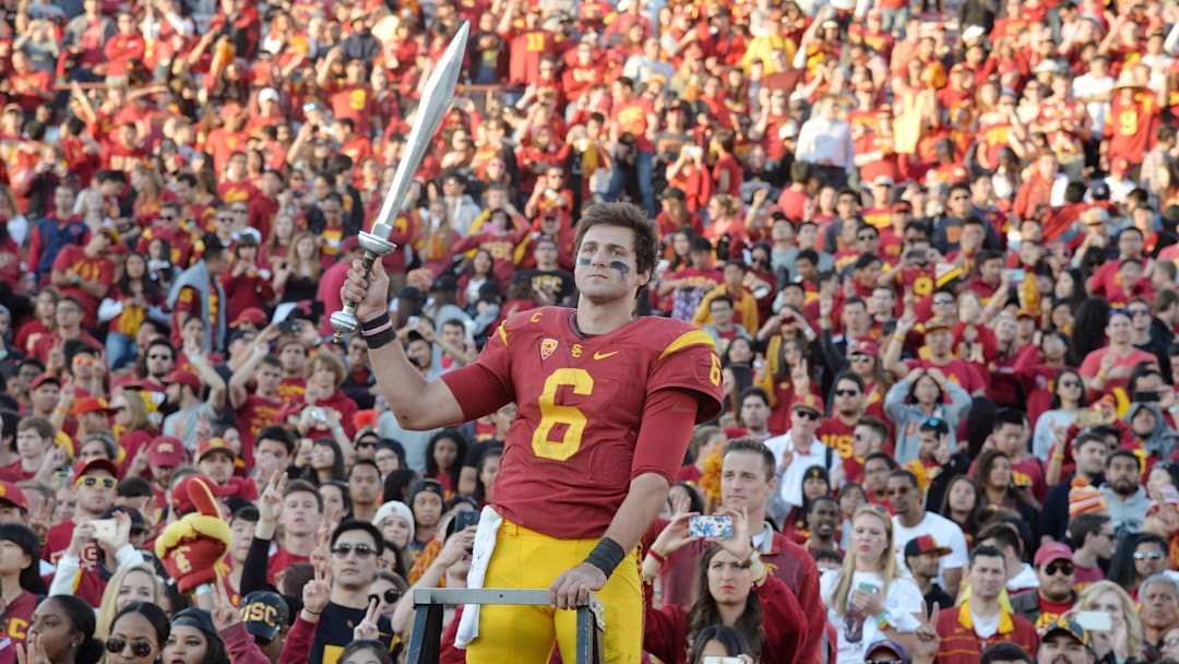 Nov 28, 2015; Los Angeles, CA, USA; Southern California Trojans quarterback Cody Kessler (6) conducts the Spirit of Troy marching band with a sword after an NCAA football game against the UCLA Bruins at Los Angeles Memorial Coliseum. USC defeated UCLA 40-21. Mandatory Credit: Kirby Lee-Imagn Images