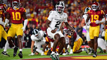 Sep 20, 2025; Los Angeles, California, USA; Michigan State Spartans quarterback Aidan Chiles (2) scores a touchdown against the Southern California Trojans during the second half at the Los Angeles Memorial Coliseum. Mandatory Credit: Gary A. Vasquez-Imagn Images