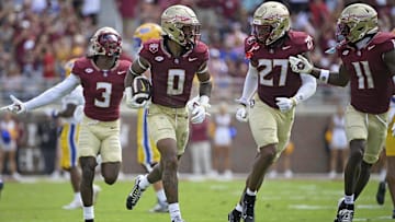 Oct 11, 2025; Tallahassee, Florida, USA; Florida State Seminoles safety Earl Little Jr. (0), defensive back Ashlynd Barker (27), defensive back Edwin Joseph (3), and defensive back Ja'Bril Rawls (11) celebrate after an interception during the first half of the game against the Pittsburgh Panthers at Doak S. Campbell Stadium. Mandatory Credit: Melina Myers-Imagn Images