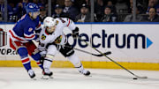 Dec 9, 2024; New York, New York, USA; New York Rangers defenseman Zac Jones (6) and Chicago Blackhawks center Connor Bedard (98) fight for the puck during the second period at Madison Square Garden. Mandatory Credit: Brad Penner-Imagn Images