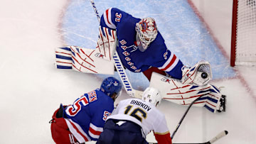 May 30, 2024; New York, New York, USA; New York Rangers goaltender Igor Shesterkin (31) makes a save against Florida Panthers center Aleksander Barkov (16) in front of Rangers defenseman Ryan Lindgren (55) during the third period of game five of the Eastern Conference Final of the 2024 Stanley Cup Playoffs at Madison Square Garden. Mandatory Credit: Brad Penner-Imagn Images