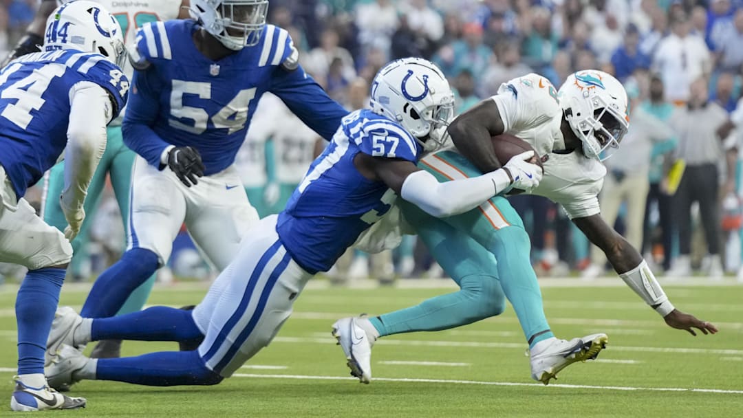Oct 20, 2024; Indianapolis, Indiana, USA; Indianapolis Colts linebacker Jaylon Carlies (57) sacks Miami Dolphins quarterback Tyler Huntley (18) during a game against the Miami Dolphins at Lucas Oil Stadium. Mandatory Credit: Grace Hollars/IndyStar USA TODAY Network via Imagn Images