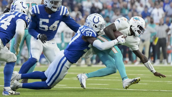 Oct 20, 2024; Indianapolis, Indiana, USA; Indianapolis Colts linebacker Jaylon Carlies (57) sacks Miami Dolphins quarterback Tyler Huntley (18) during a game against the Miami Dolphins at Lucas Oil Stadium. Mandatory Credit: Grace Hollars/IndyStar USA TODAY Network via Imagn Images