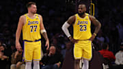 Los Angeles Lakers guard Luka Doncic (77) and forward LeBron James (23) stand on the court during the second quarter against the Minnesota Timberwolves at Crypto.com Arena.