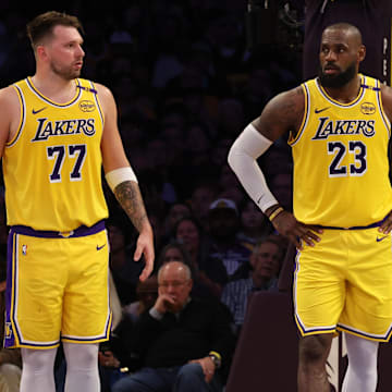 Los Angeles Lakers guard Luka Doncic (77) and forward LeBron James (23) stand on the court during the second quarter against the Minnesota Timberwolves at Crypto.com Arena.