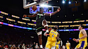 Apr 11, 2023; Los Angeles, California, USA; Minnesota Timberwolves guard Anthony Edwards (1) scores a basket ahead of Los Angeles Lakers forward LeBron James (6) during the second half at Crypto.com Arena. Mandatory Credit: Gary A. Vasquez-Imagn Images