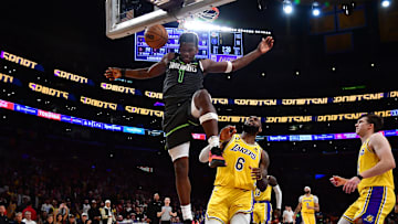 Apr 11, 2023; Los Angeles, California, USA; Minnesota Timberwolves guard Anthony Edwards (1) scores a basket ahead of Los Angeles Lakers forward LeBron James (6) during the second half at Crypto.com Arena. Mandatory Credit: Gary A. Vasquez-Imagn Images