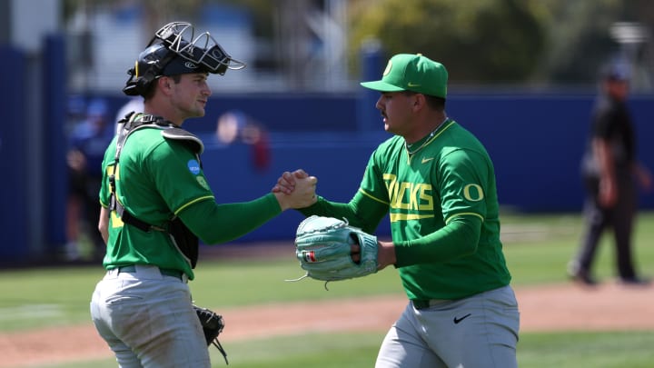 May 31, 2024; Santa Barbara, CA, USA;  Oregon pitcher Logan Mercado (20) celebrates with catcher Bennett Thompson (16) after defeating San Diego 5-4 in extra innings of an NCAA Baseball Santa Barbara Regional game at Caesar Uyesaka Stadium. Mandatory Credit: Kiyoshi Mio-USA TODAY Sports