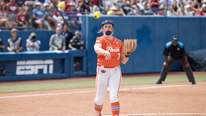 Jun 3, 2024;  Oklahoma City, OK, USA;  Florida Gators starting pitcher/relief pitcher Keagan Rothrock (7) throws the ball to first for an out in the fifth inning against the Oklahoma Sooners during a Women's College World Series softball semifinal game at Devon Park. Mandatory Credit: Brett Rojo-Imagn Images